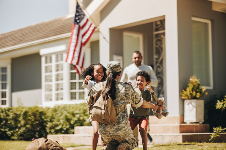 service woman holding children returning home